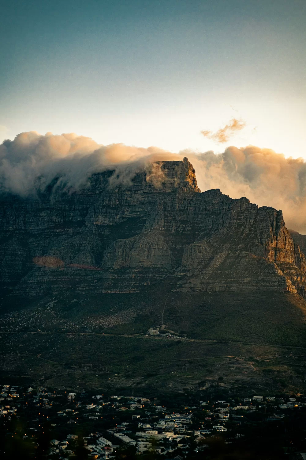 Cape Town mountain peaks with cloud rolling over at golden hour